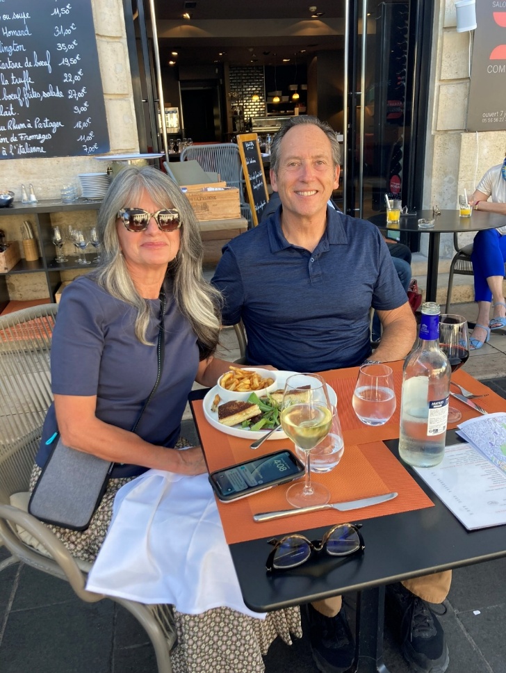 A man and woman enjoy a meal together at a table