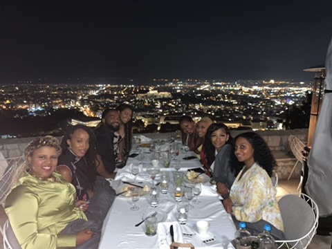 People sitting together at a table with a panoramic view
