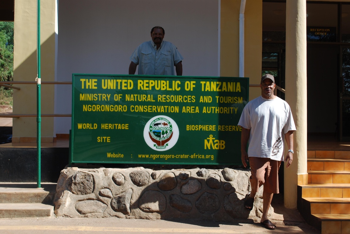 A man stands in front of a sign