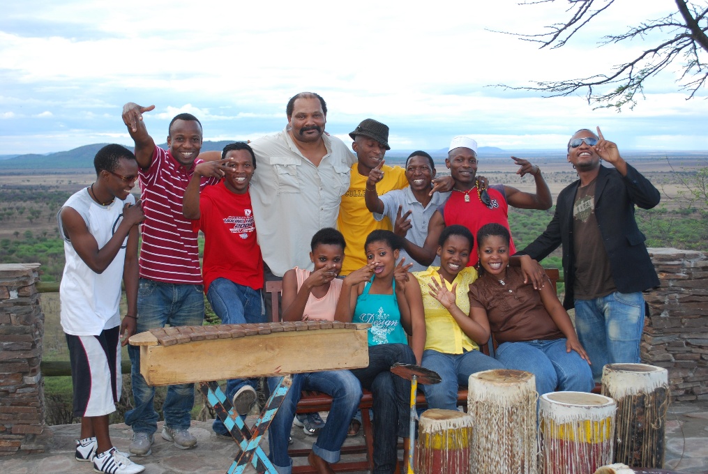 A diverse group of people smiling and posing together for a photograph outdoors