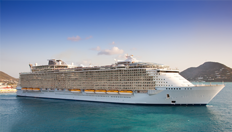 A large cruise ship sailing through the ocean under a clear blue sky