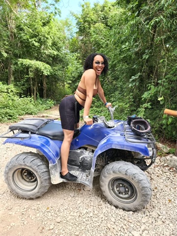 A woman  riding an ATV